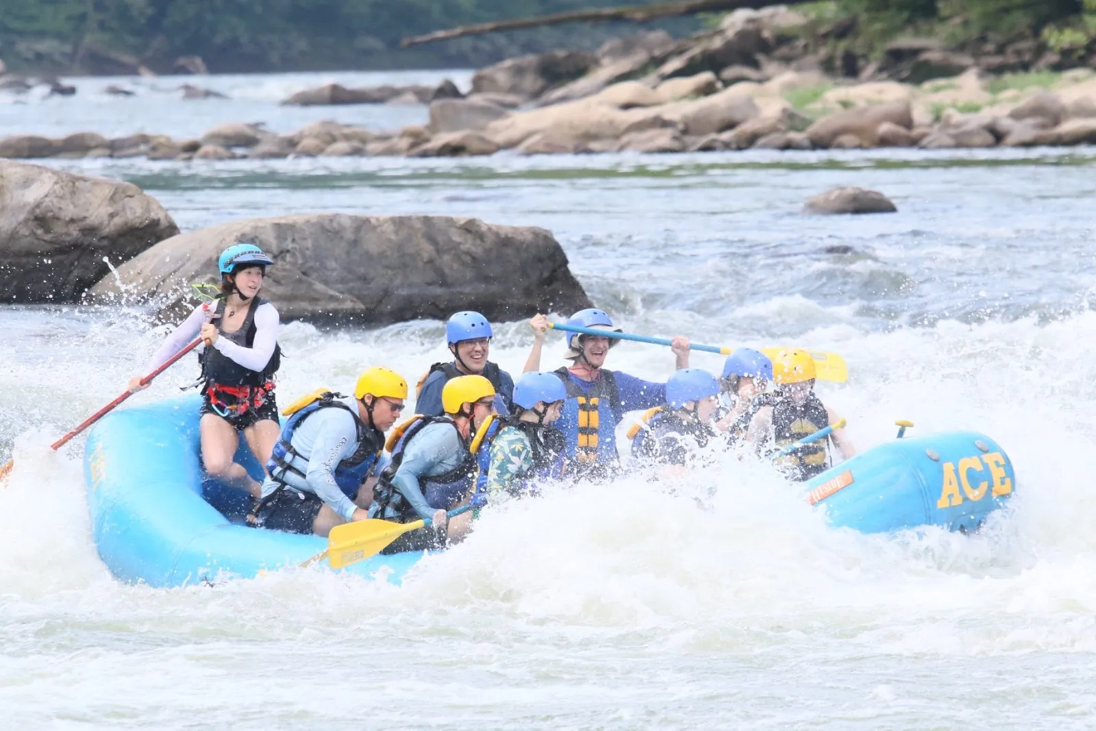 Troop 700 Scouts paddling a raft through whitewater