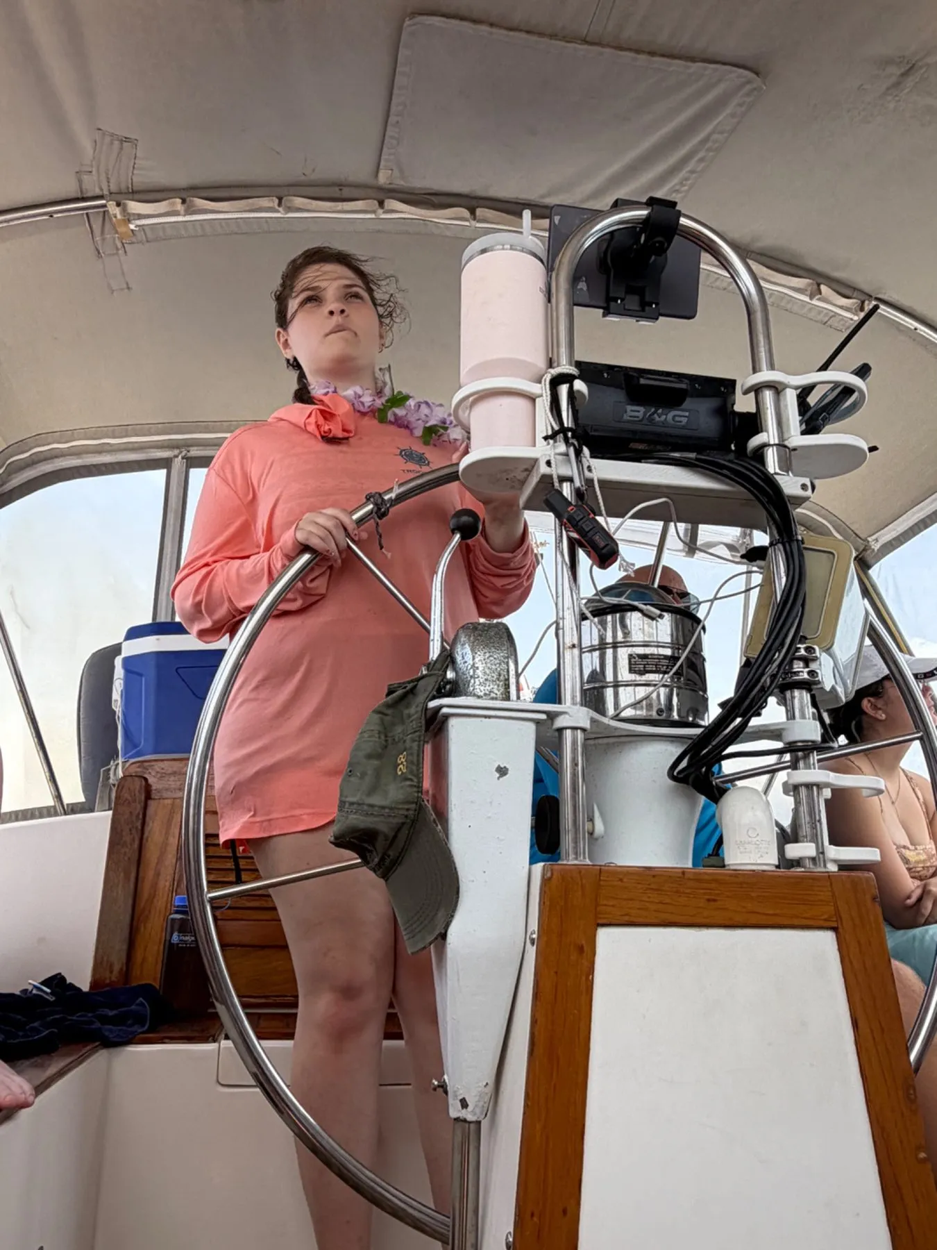 A Scout steering a sailboat at the helm